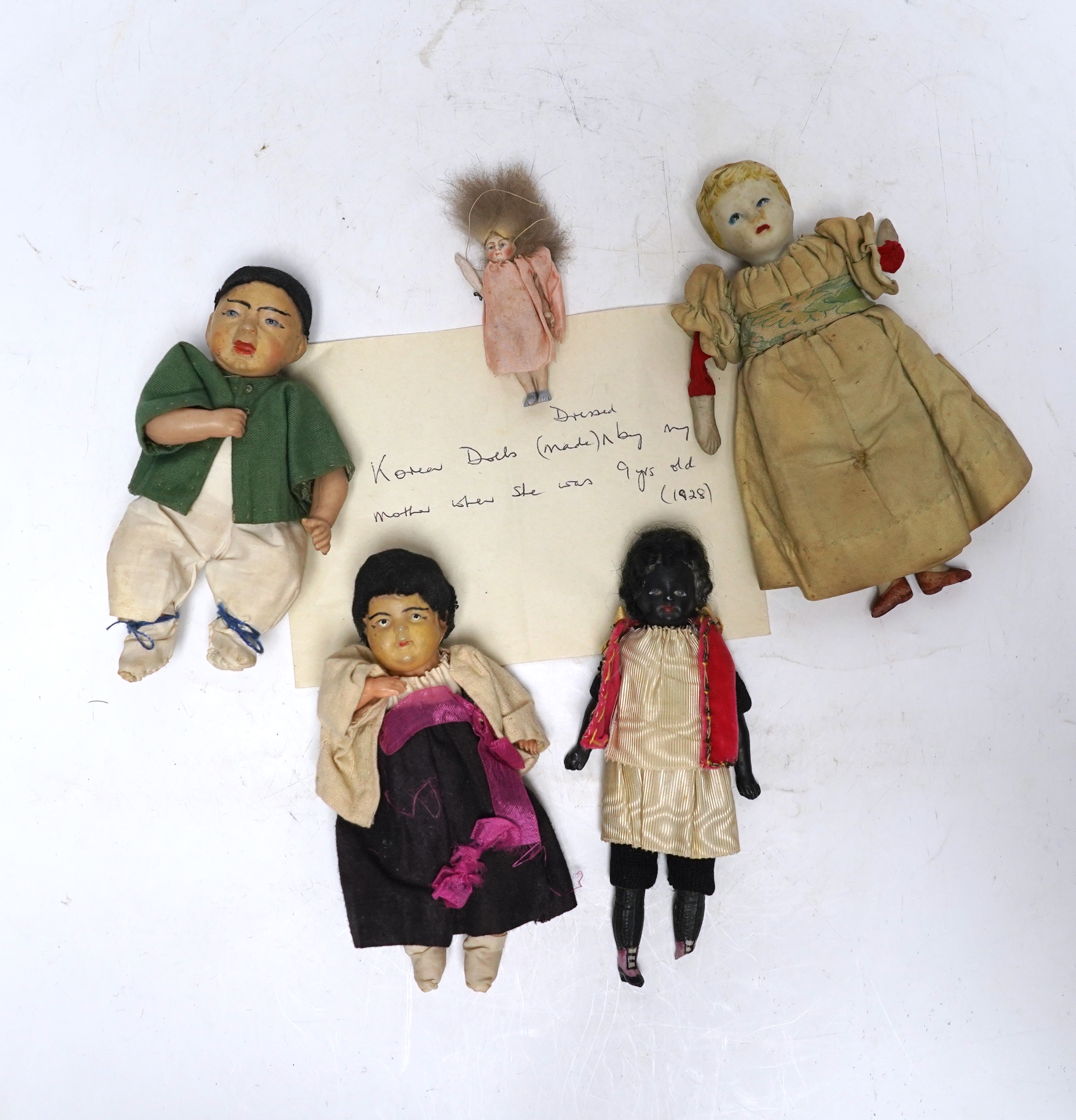 Five various small world dolls, two celluloid and three bisque/china, largest 15cm high